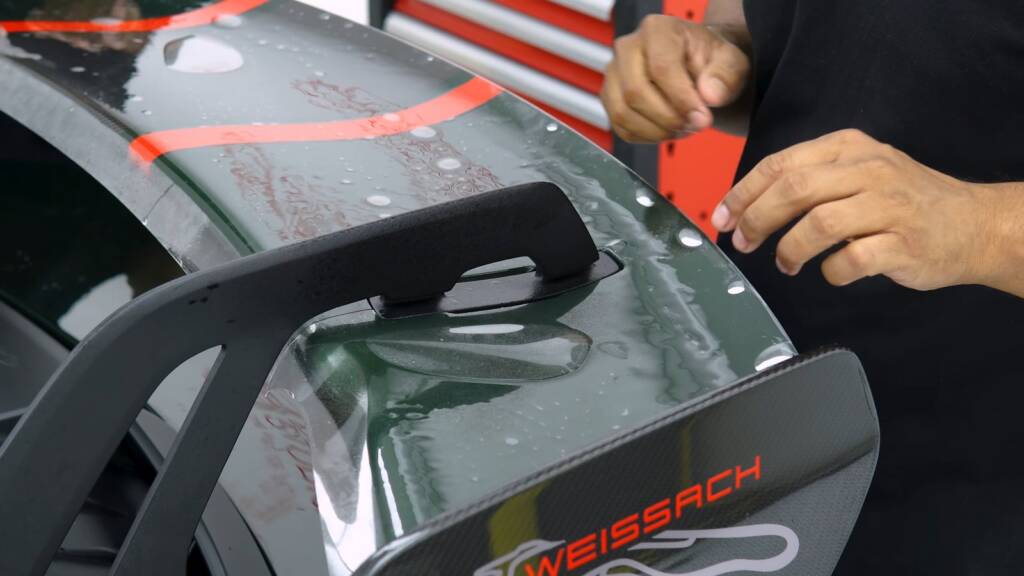 PPF fitted around the Weissach rear wing mounts of a Porsche 911 GT3 at Apex Detail Studio