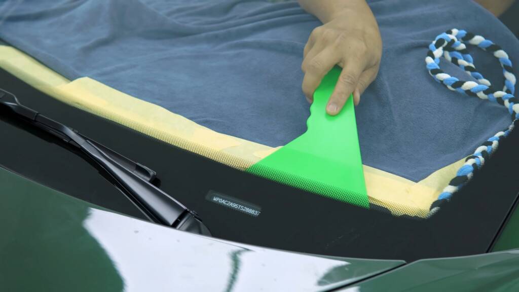 Film being squeegeed on the windscreen of a Porsche 992.2 GT3 in Dubai