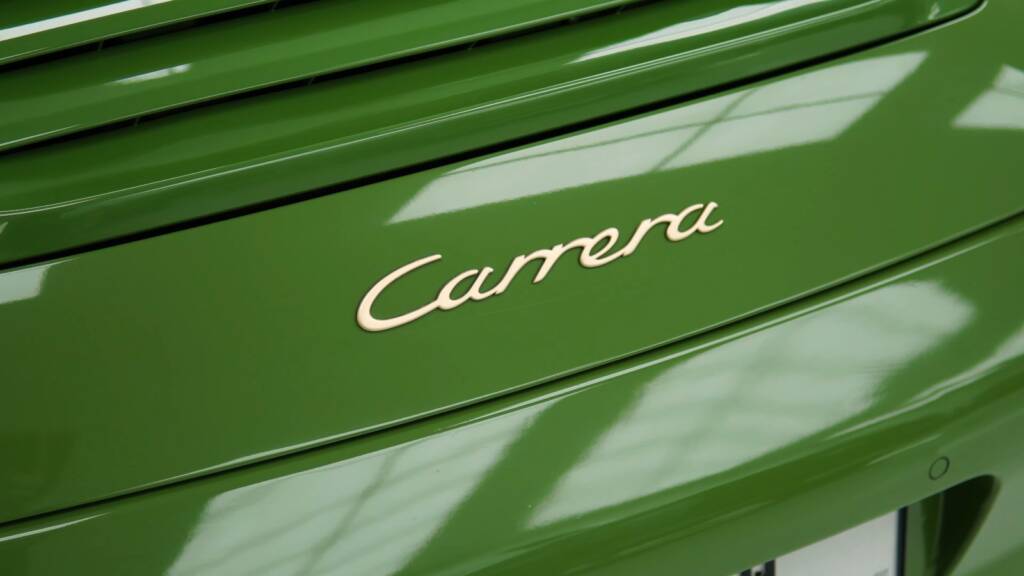 Carrera badge on a Porsche 911 997 finished in green colour PPF in Dubai