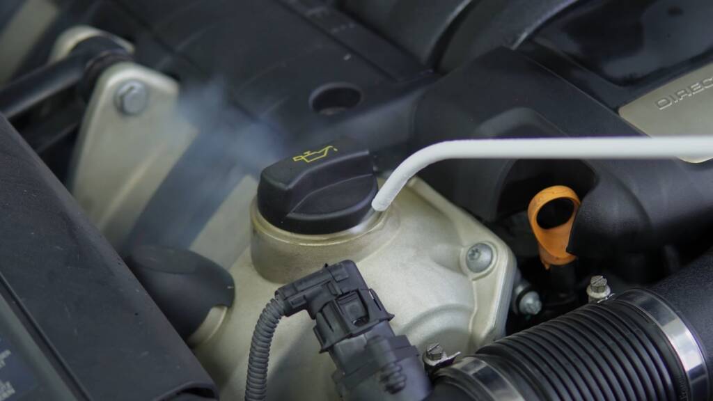 Cleaning around the reservoirs in a Porsche Cayenne engine bay