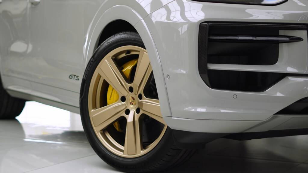 Gold wheel and yellow caliper of a 2026 Porsche Cayenne GTS after PPF in Dubai