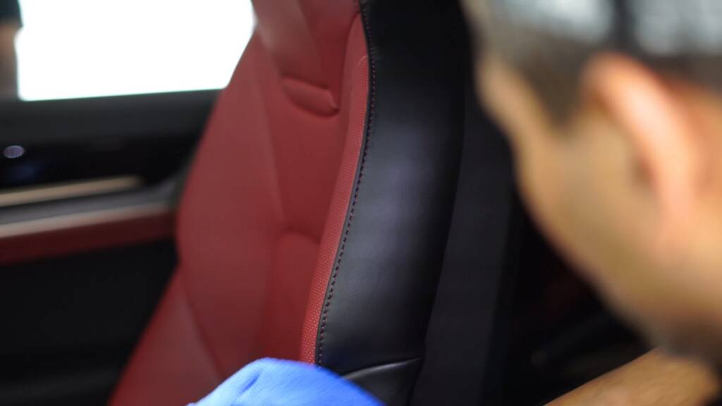 Red leather seats of a 2026 Porsche Cayenne GTS being cleaned
