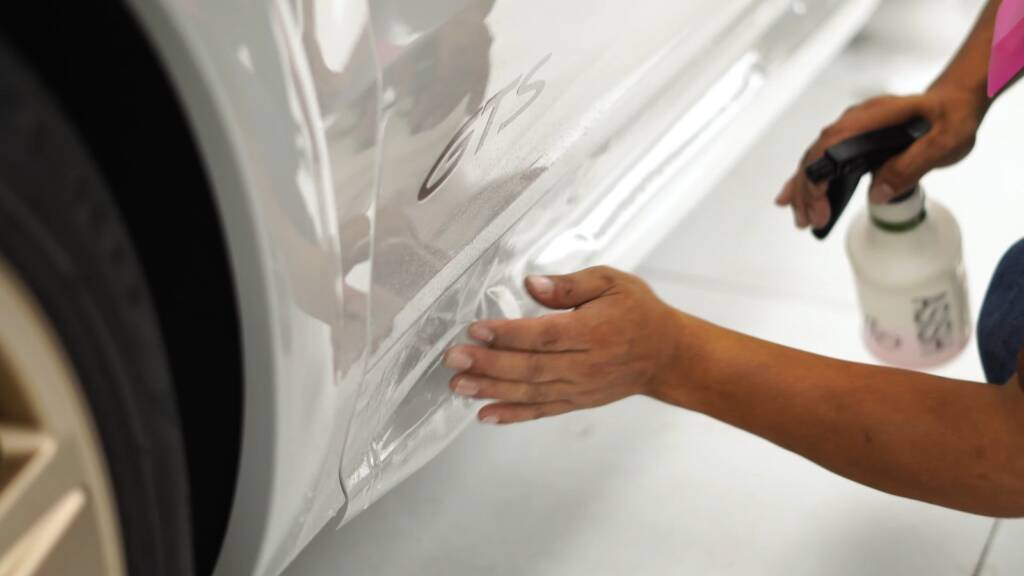 Slip solution being sprayed on a Porsche Cayenne GTS before PPF