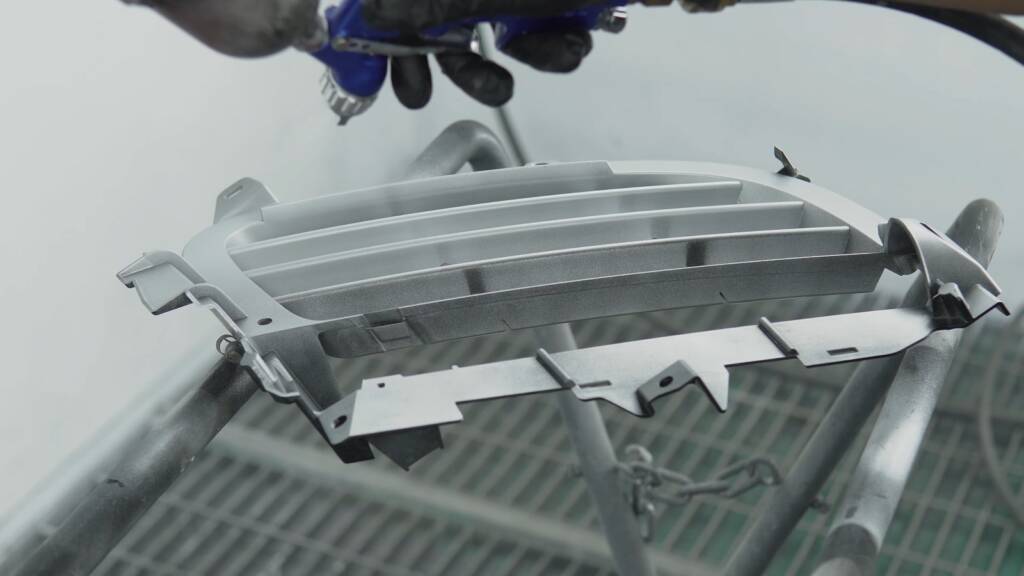 Porsche Cayenne grille freshly painted silver in the Apex spray booth