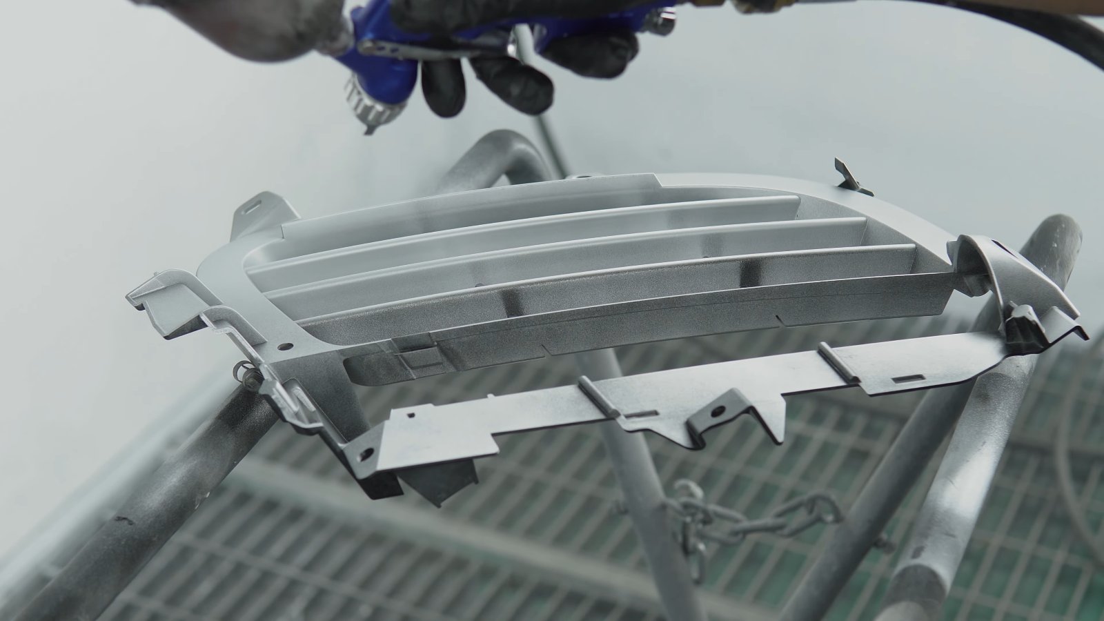 Silver paint going onto a Porsche Cayenne grille