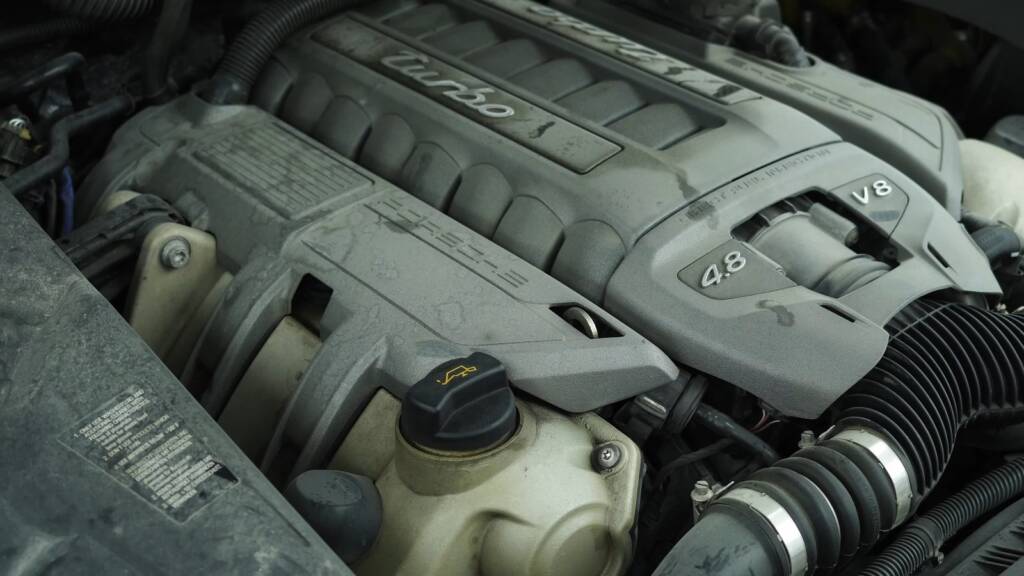 Porsche Cayenne Turbo engine bay before dry ice detailing in Dubai