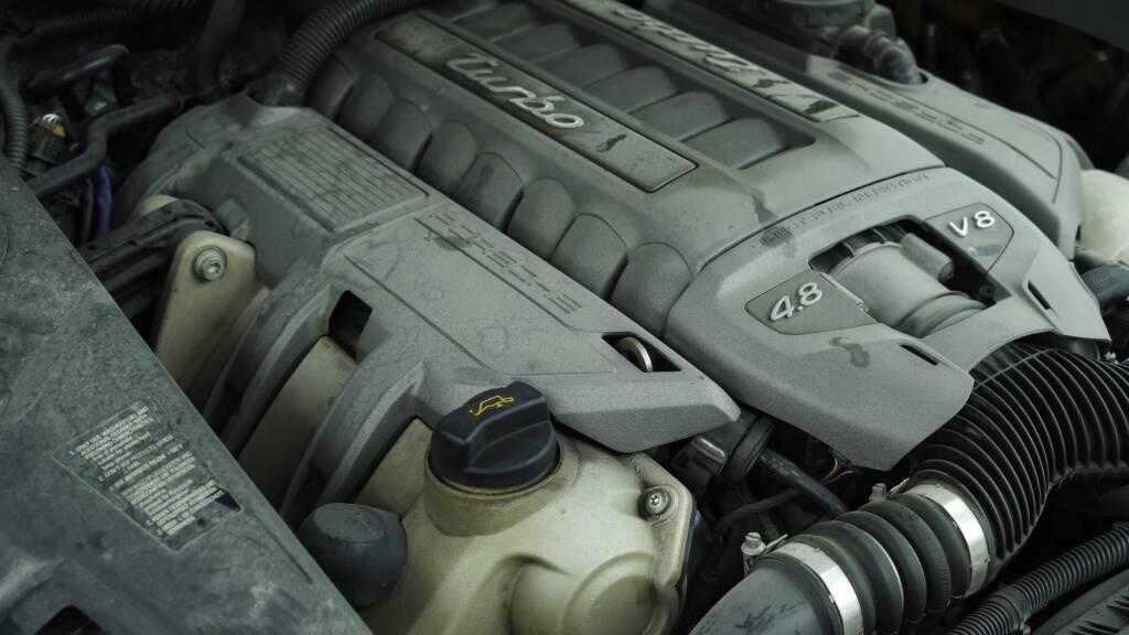 Porsche Cayenne Turbo engine bay reservoirs before cleaning