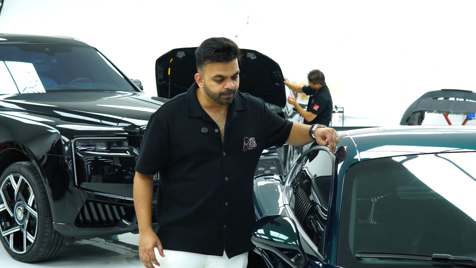 Apex team member explaining the finish on a Porsche Cayman GT4 colour change