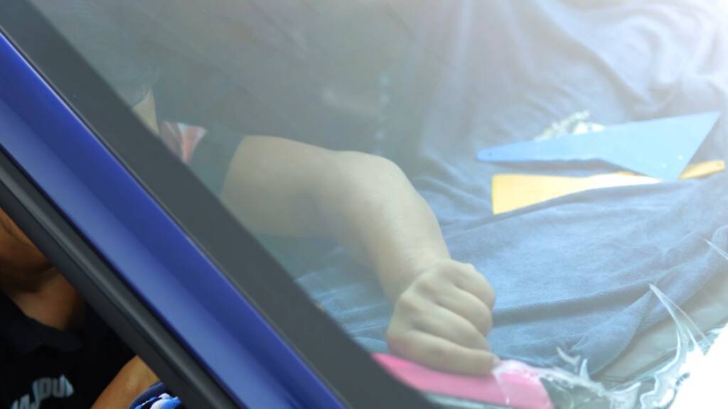 Tint being fitted to the door glass of a Porsche Taycan in Dubai