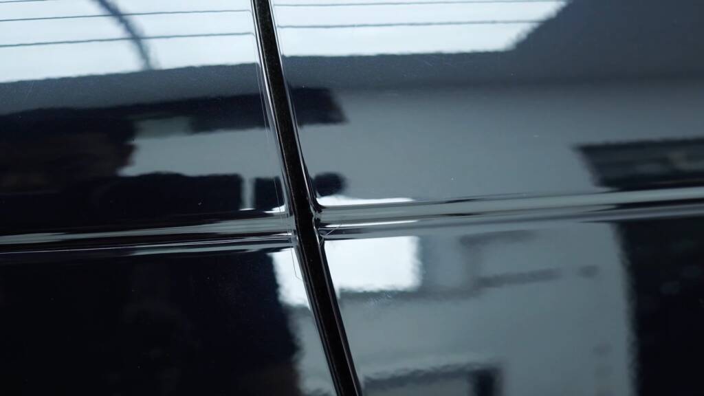 Close up of a hand-cut PPF line on a Range Rover