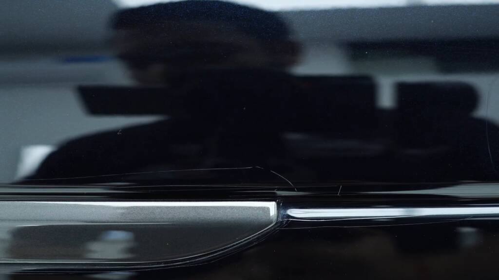 Range Rover door bottom edge with hand-cut PPF damage