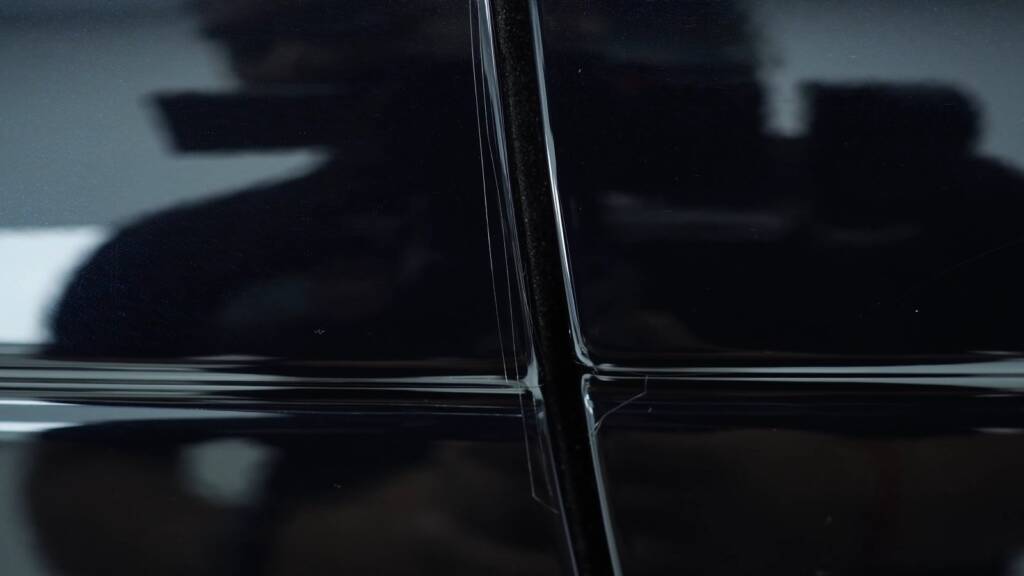 Hand-cut PPF damage at a Range Rover panel gap