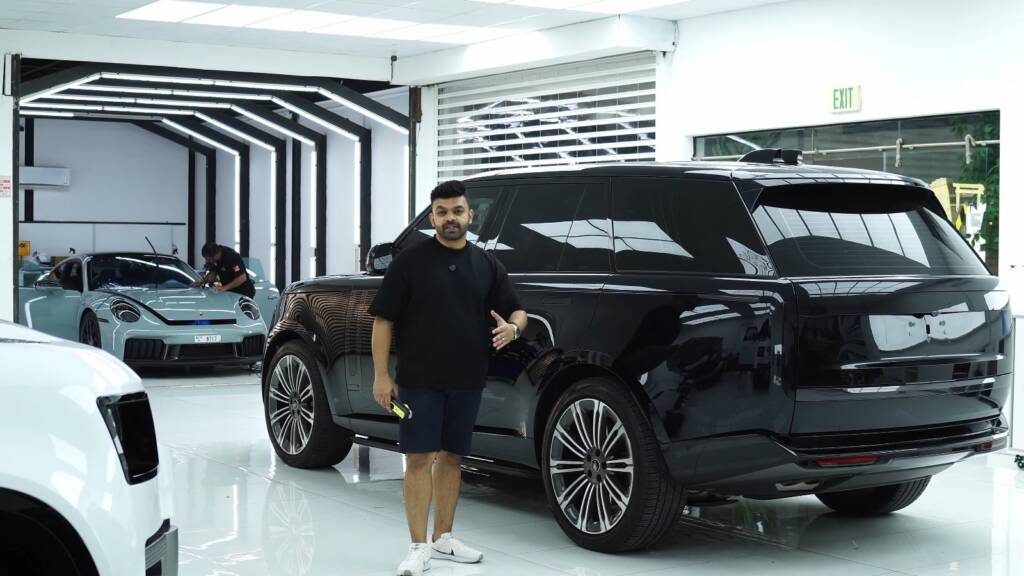 Explaining precut PPF next to a black Range Rover