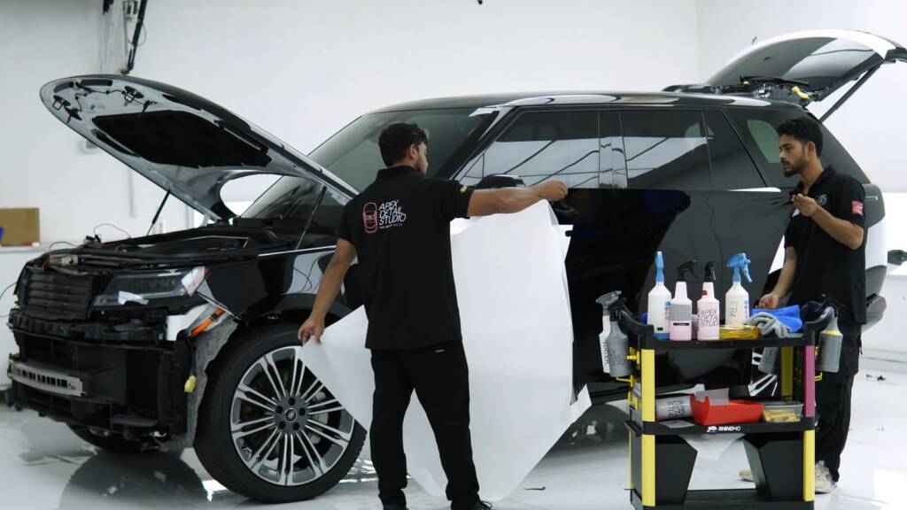 Range Rover half white and half gloss black during colour change PPF in Dubai