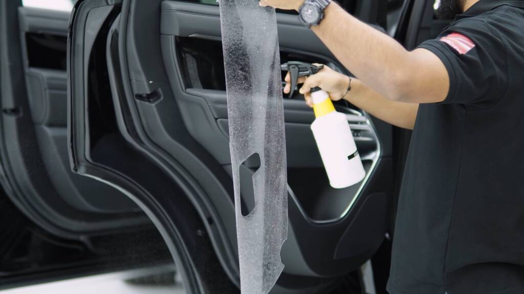 Installer preparing interior trim of a Range Rover for protection film