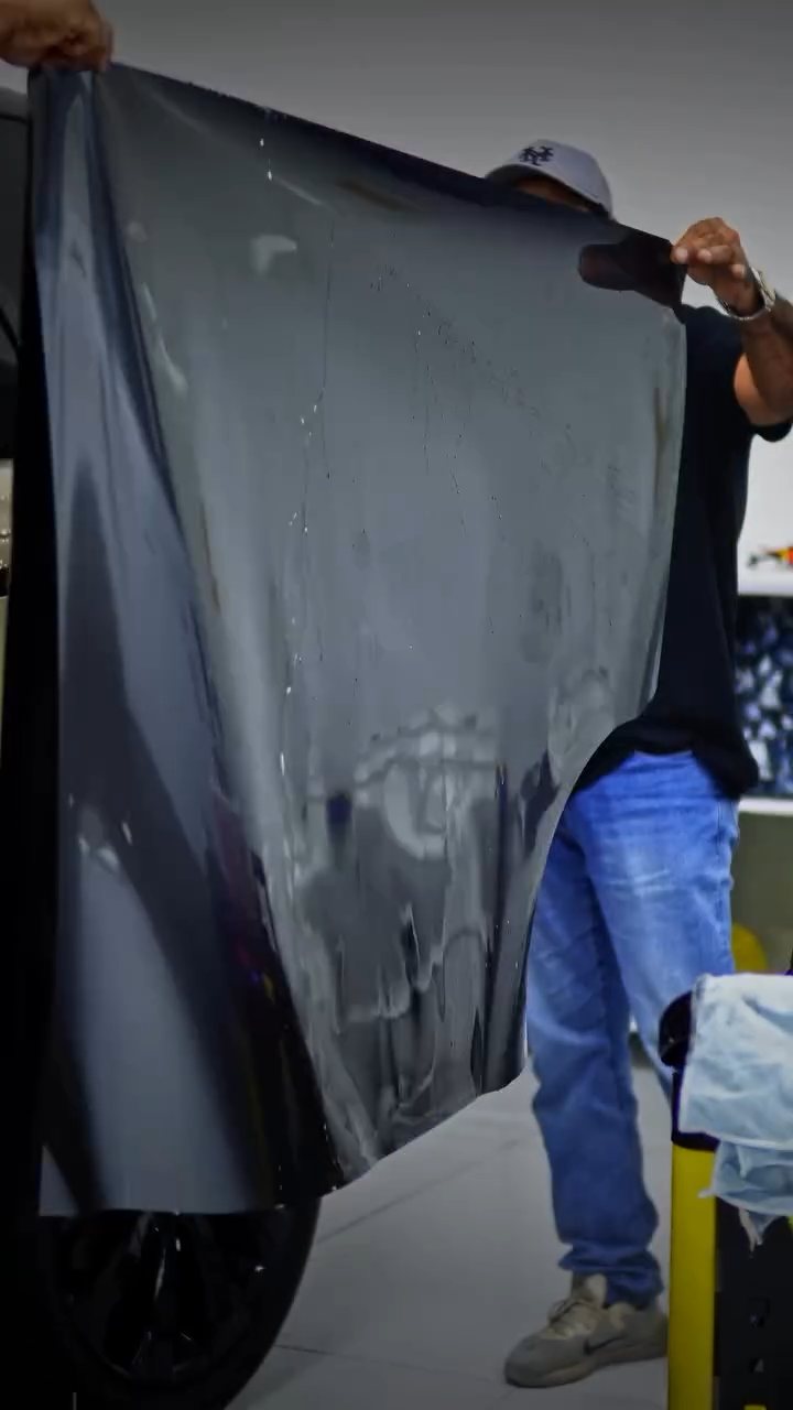 Apex installer unrolling grey colour PPF for the Range Rover in Dubai