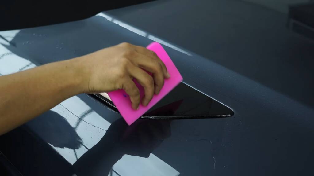 Squeegee on PPF at a Range Rover Sport side vent