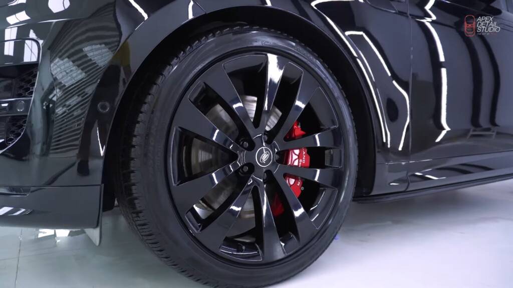 Black wheel with red caliper on a Range Rover Sport after detailing at Apex Detail Studio Dubai