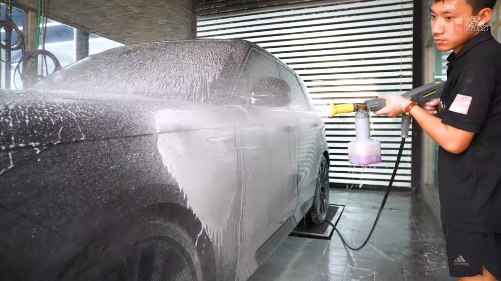 Black Range Rover Sport covered in snow foam during a detailed wash at Apex Detail Studio