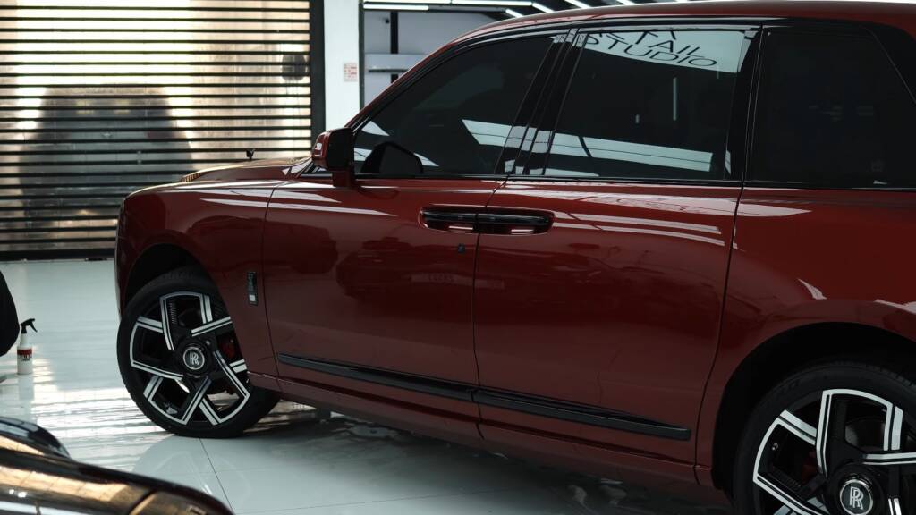 Red Rolls-Royce Cullinan side with tinted windows