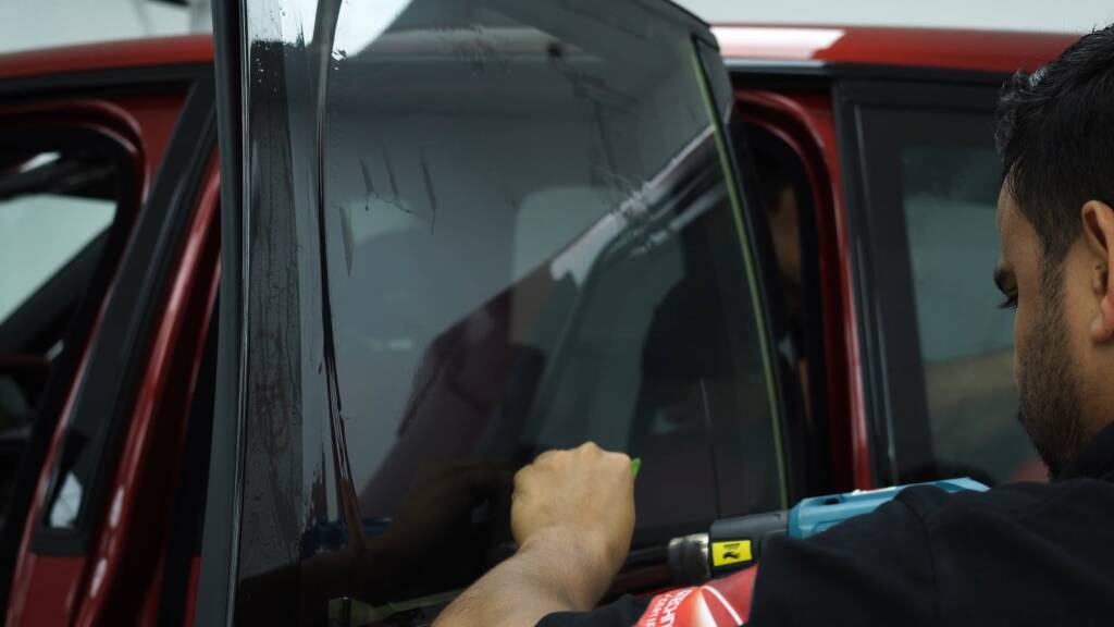 Fitting window tint to a red 2025 Rolls-Royce Cullinan in Dubai