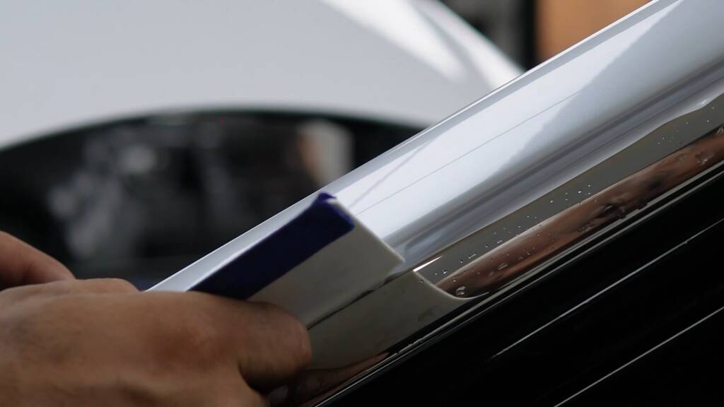 White colour PPF being wrapped around the pillar of a Rolls-Royce Ghost