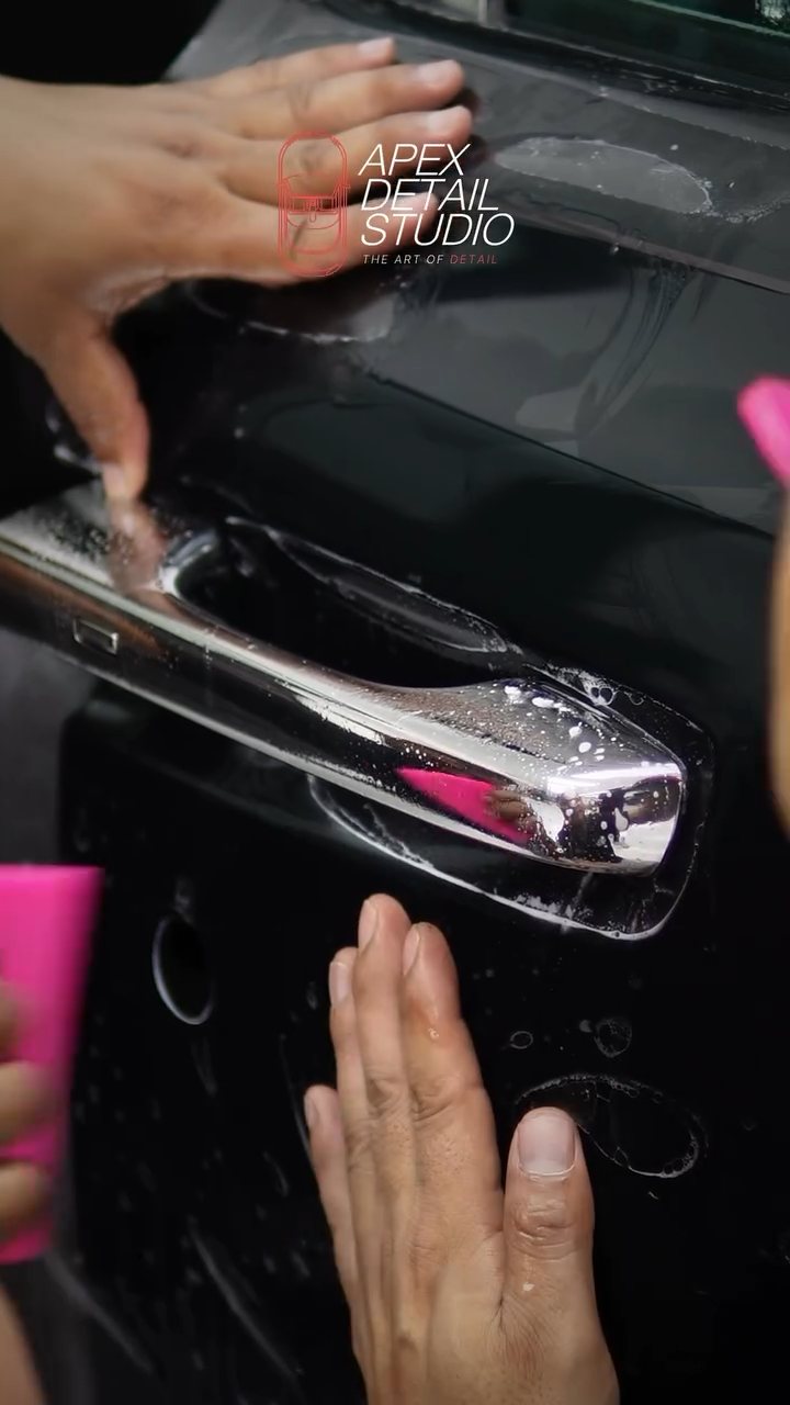 Squeegee work around the Rolls-Royce Phantom chrome door handle at Apex Detail Studio