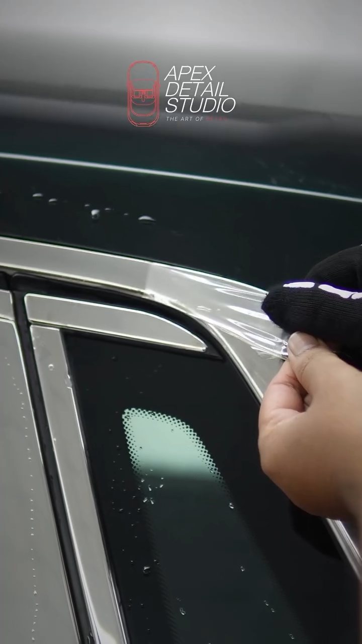 Installer working PPF along the Rolls-Royce Phantom window trim at Apex Detail Studio Dubai