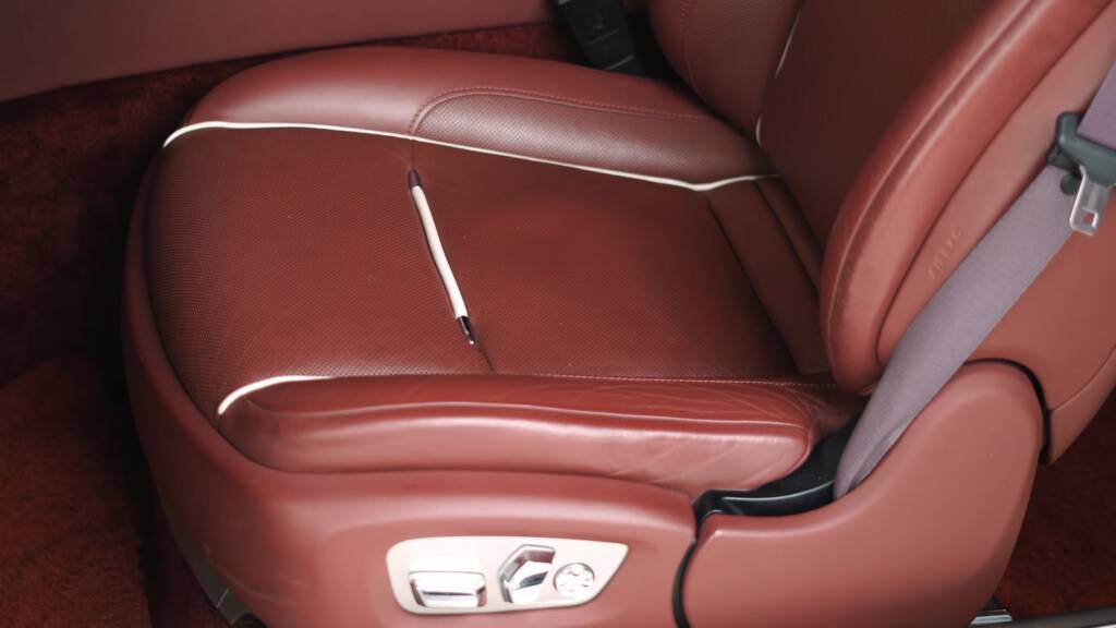 White Rolls-Royce Wraith red leather driver seat before cleaning