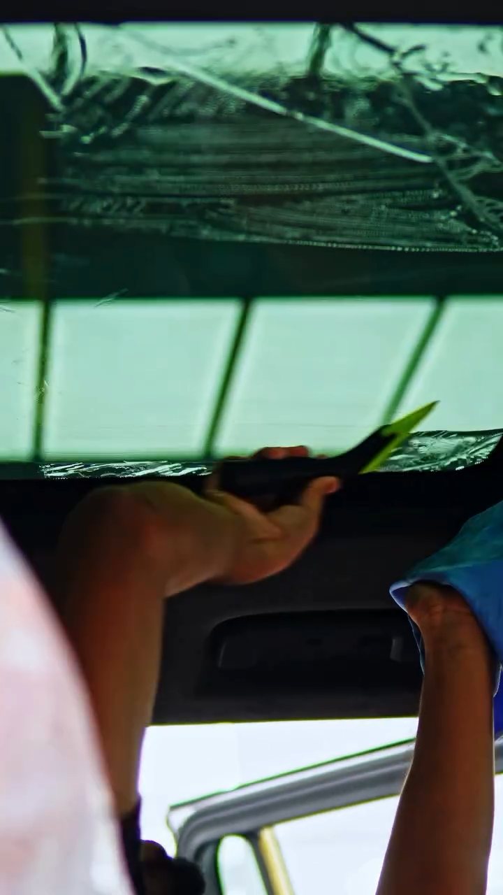 Installers working on the ROX Adamas roof glass tint at Apex Detail Studio