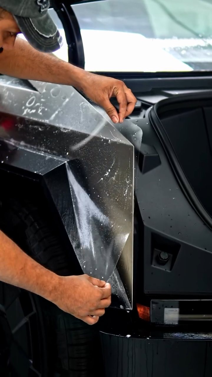 Installer fitting PPF on the Tesla Cybertruck front corner at Apex Detail Studio Dubai