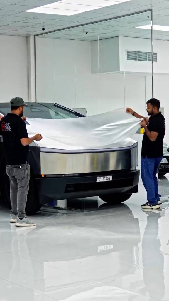 Apex Detail Studio team laying clear PPF across the front of a Tesla Cybertruck in Dubai