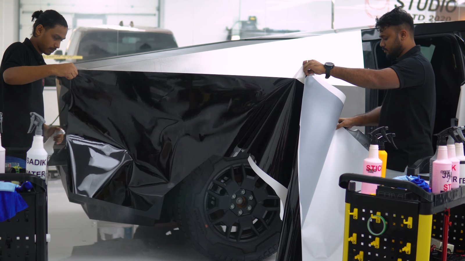 Gloss black colour PPF being applied to a Tesla Cybertruck door