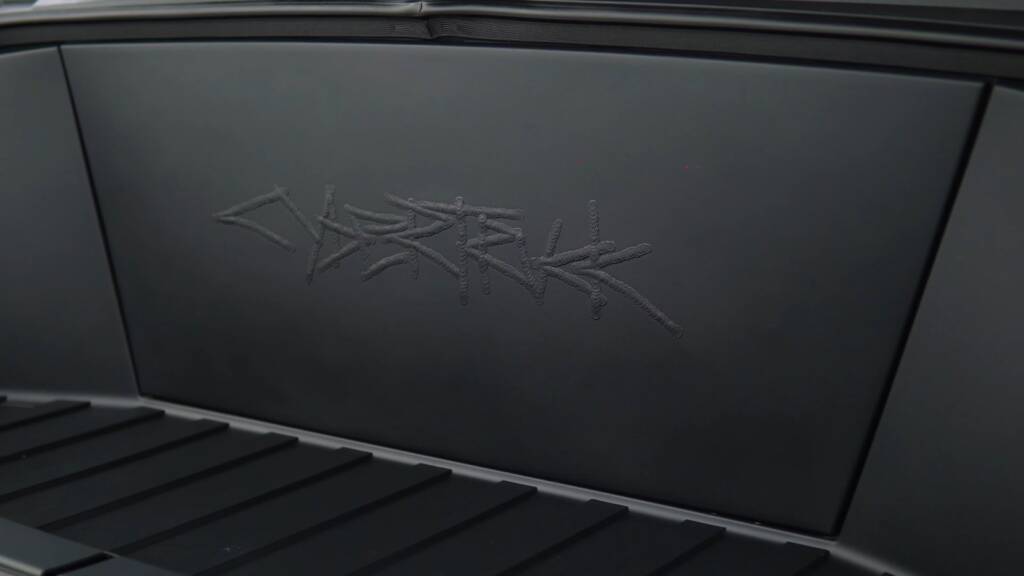 Finished gloss black tailgate of a Tesla Cybertruck after colour PPF