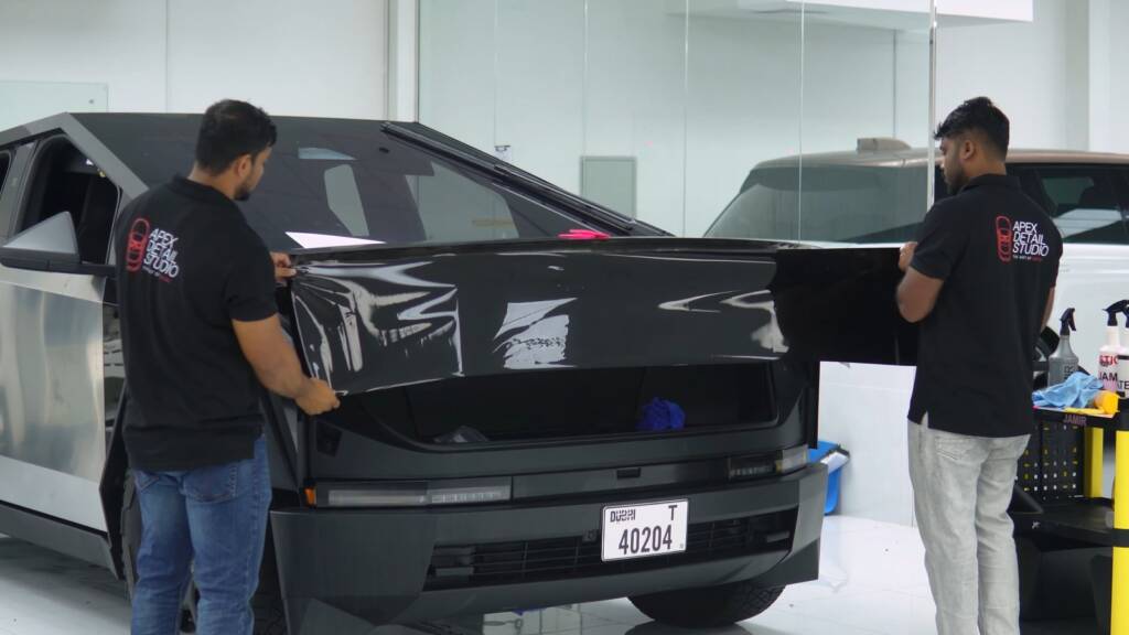 Apex installers fitting gloss black colour PPF to the tailgate of a Tesla Cybertruck in Dubai