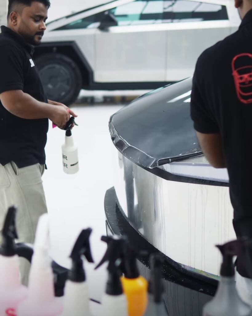 Apex Detail Studio installer preparing slip solution before fitting green PPF to a Tesla Cybertruck in Dubai