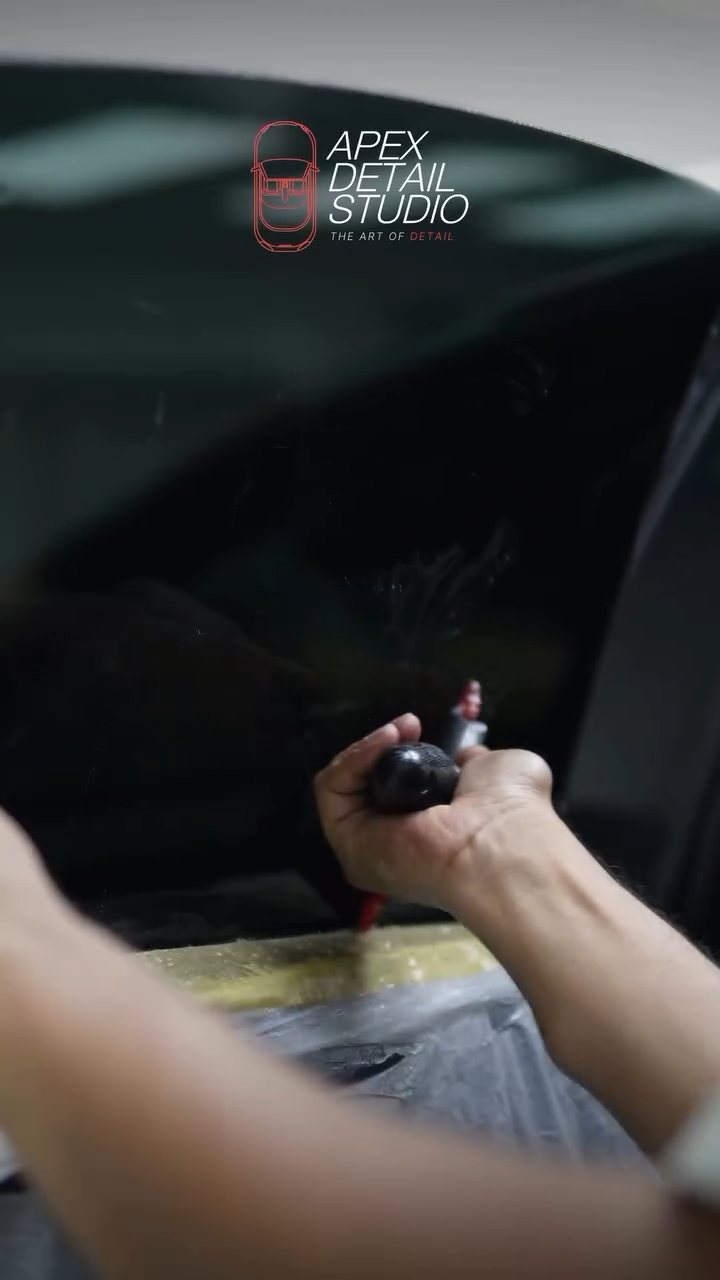 Checking the Tesla Model 3 tint edge at Apex Detail Studio Dubai