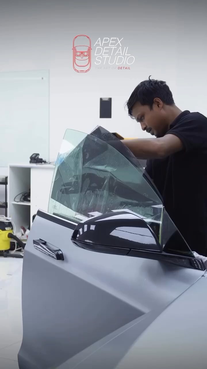 Apex installer fitting tint to the Tesla Model S Plaid door glass in Dubai
