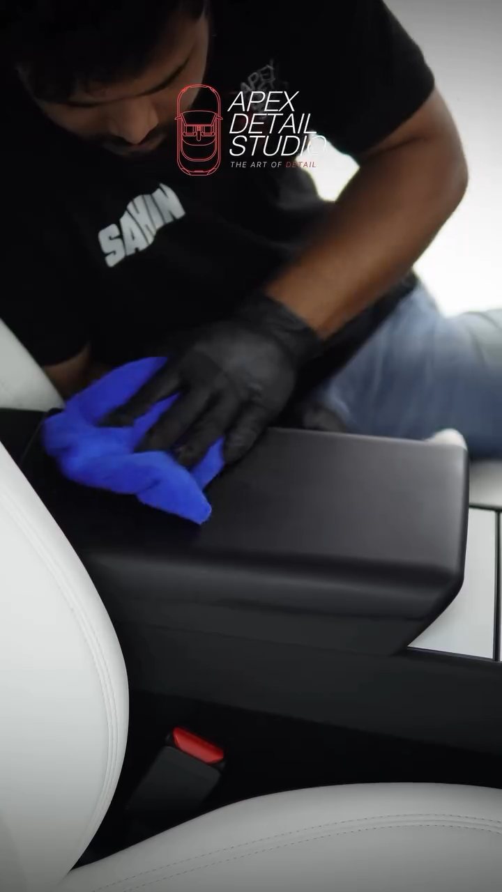 Microfibre buff on the Tesla Model Y console after coating at Apex Detail Studio