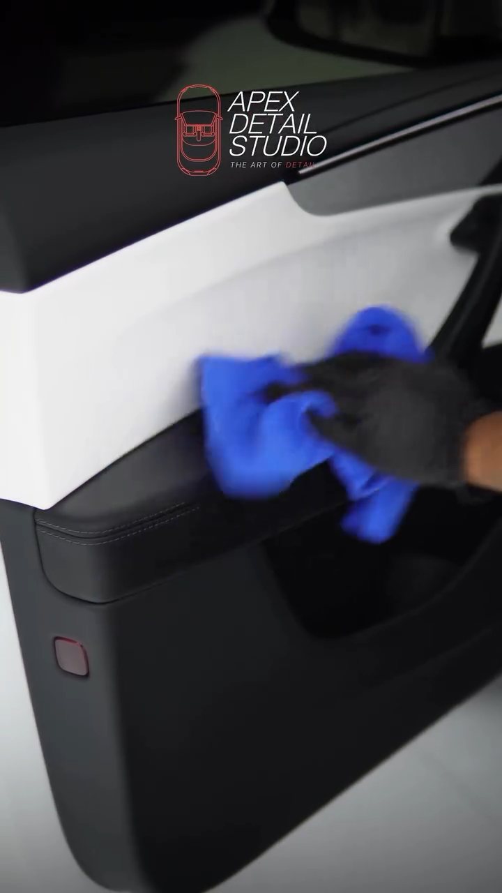 Detailer buffing the Tesla Model Y door panel coating in Dubai