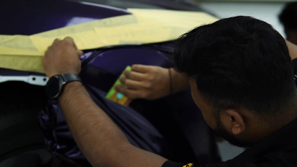 Masking tape on a Tesla Model Y Juniper during purple wrap
