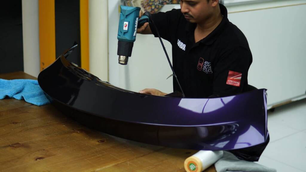 Heat gun on a Tesla Model Y Juniper spoiler being wrapped