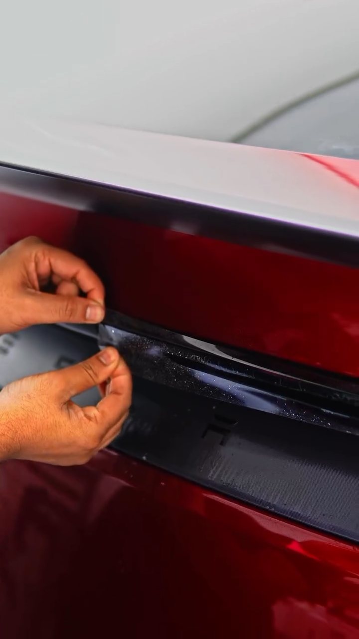 Installer wrapping a PPF edge on the Tesla Model Y Performance