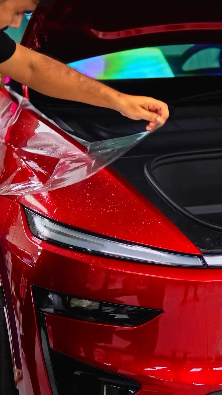 PPF being laid across the Tesla Model Y Performance front light bar in Dubai