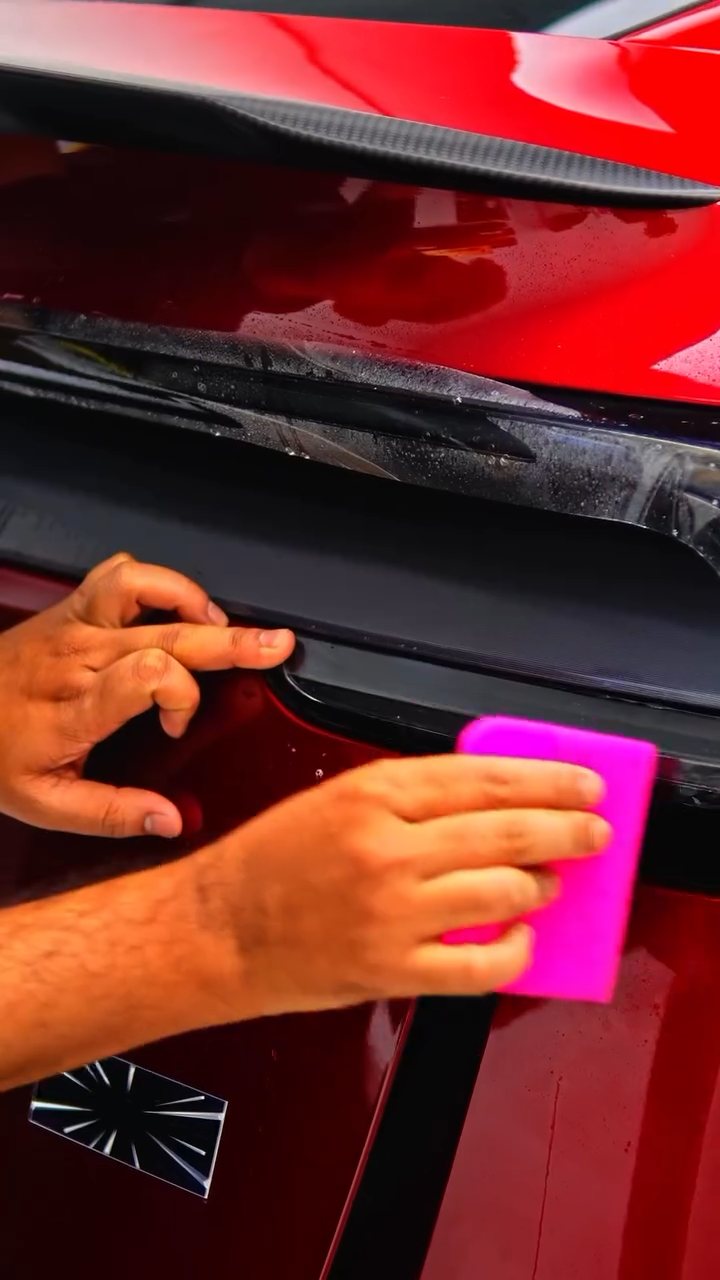 Squeegee on the Tesla Model Y Performance rear bumper PPF at Apex Detail Studio