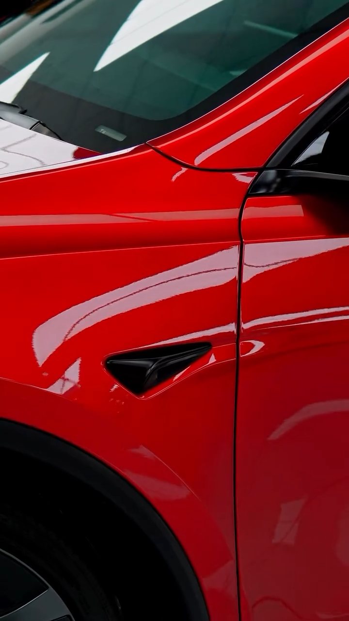 Red Tesla Model Y Performance side and wing after full body PPF at Apex Detail Studio Dubai