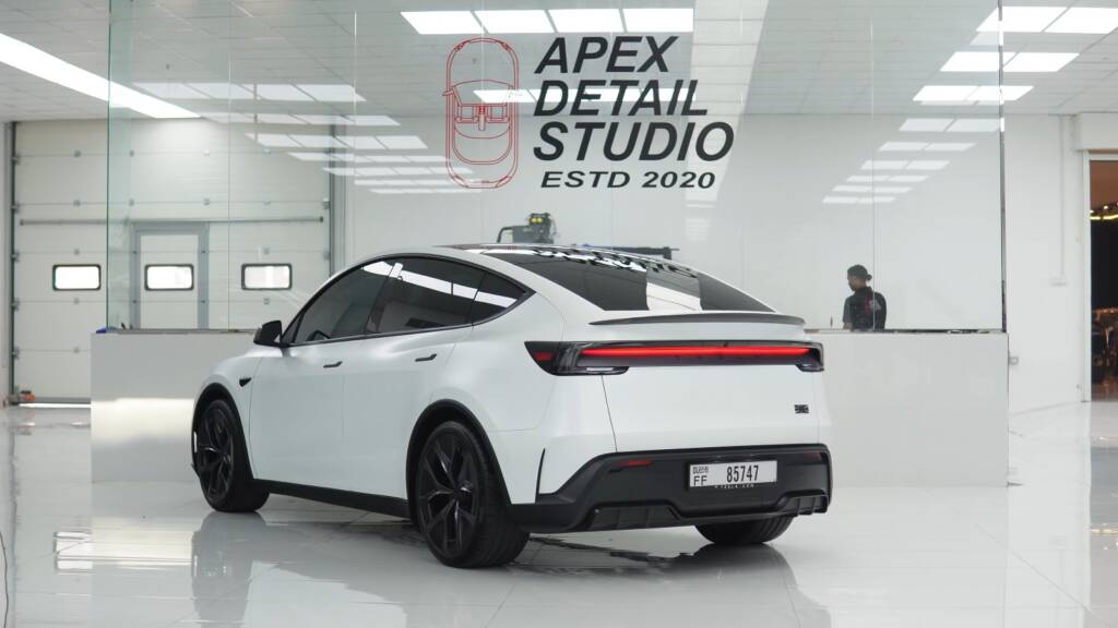 Finished white Tesla Model Y Performance with satin stealth PPF in the Apex Detail Studio showroom