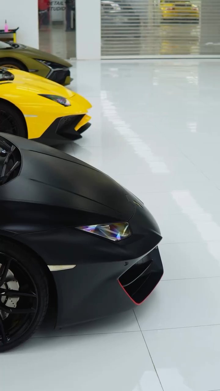 Matte black Lamborghini Huracan nose next to the yellow Aventador SV at Apex Detail Studio