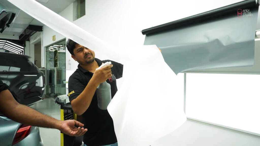 Roll of satin paint protection film being unrolled at Apex Detail Studio Dubai