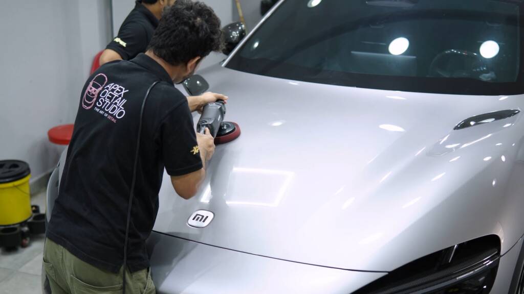 Detailer polishing the bonnet of a Xiaomi YU7 Max before ceramic coating in Dubai
